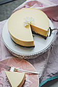 A cheesecake with a chocolate base, nectarines and oranges