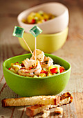 Summer party snack: mango and cucumber salad with fried shrimps and toasted bread