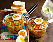 Vegetarian vegetable jelly with agar agar, boiled egg, baguette slices and chive sauce