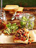 Crostini with marinated zucchini and tomatoes and capers