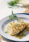 Grilled fish fillet on fennel slices