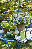 Easter arrangement with a grass Easter nest, Easter bunny, pansies, and lettuce