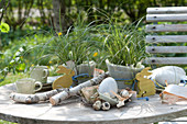 Easter decorations on the terrace table with sedge wrapped n felt, Easter eggs, Easter bunnies, and birch wood