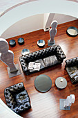 View down onto leather sofa set and sculptures in loft apartment