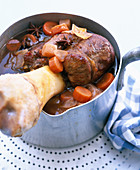 Veal shank with vegetables in a pot