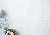 A white fabric background and Easter decoration in the corner