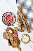 Baguette with sunflower seeds served with cheese and salami