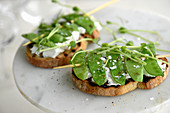 Grilled sweat peas on sourdough bread with goat's cheese