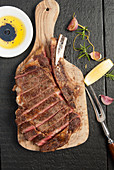 Carved ribeye steak on cutting board