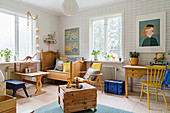 Bright nursery with patterned wallpaper and wooden furniture
