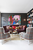 Sofa, tartan armchairs and huge portrait of woman in eclectic living room