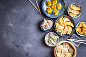 Assorted dim sum appetizers on rustic background