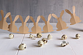 Garland of brown paper Easter bunnies and quail eggs