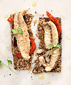 Mackerel filets on seed crackers with roasted red peppers and micro greens