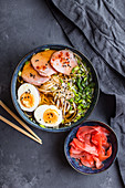 Traditional Japanese soup ramen with meat broth, asian noodles, seaweed, sliced pork, eggs and ginger