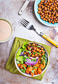 Healthy vegetarian salad with vegetables, sweet potato, chickpea, salad leaves