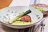 Low-cooked pork fillet with broad bean puree and braised green onion