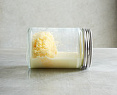 Cream in a screw-top jar being shaken for 3–4 minutes to make butter