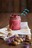 Raspberry smoothie in glass jar with almond milk