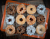 Donuts with chopped nutes, powdered sugar and ganache