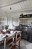 Dining table in rustic kitchen with chequered floor