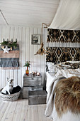 Dog in basket next to bed in rustic bedroom