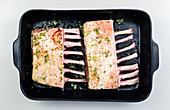 Raw rack of lamb in a roasting tray