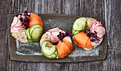 Sushi doughnuts with salmon, cucumber and radish