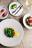 Pig face fruit, grilled garlic buds with charred kelp, ceviche served two ways with coastal plants and kangaroo tartare with coastal sunrise, pepper berry and cured egg yolk