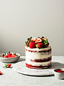 Red velvet naked cake with strawberries on top