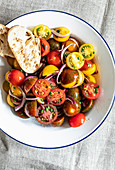 Colorful tomato salad with onions and white bread
