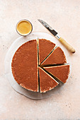 White chocolate cheesecake dusted with cocoa powder on the table