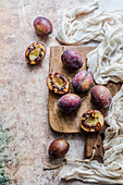 Fresh and grilled plums on a wooden board