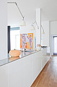 White, minimalist kitchen island used as partition