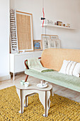 Side table with stylised animal legs in front of vintage sofa in living room