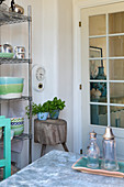 Green and blue accessories in kitchen with lattice door