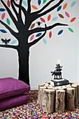 Tree painted on the wall and side table made from firewood