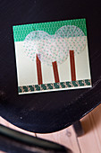 Homemade postcard made of masking tape and muffin liners with a tree motif