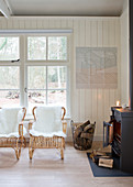 Two rattan chairs with sheepskins