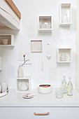 Small white wall shelves above the kitchenette