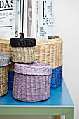 Partially painted seagrass baskets with lids and magazines