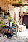 Table with banana tree and pine cones on a Mediterranean terrace