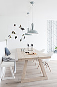 Light wooden table and bench in the Scandinavian style dining room