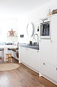 A breakfast nook for dining in a white kitchen