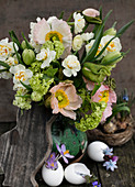 Easter bouquet with poppies, daffodils, snowball, and tulips with rustic decoration