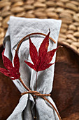 A place setting decorated with autumn leaves