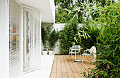 chairs on the screened terrace at a white house