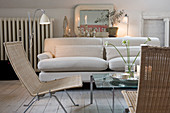 Wicker chairs and a beige sofa in a shabby chic living room