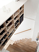 Shoe storage next to a winding staircase