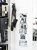 Ballettschuhe hängen neben einem Bücherregal und Schwarz-weiß-Fotos